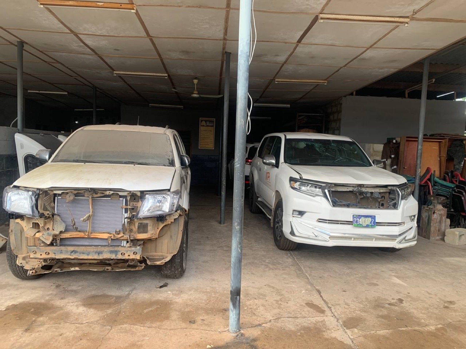 Vehicles prepared for body repair inside an auto body workshop